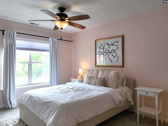 900 Taylor St Unit 304, Columbia, SC 29201 - carpeted bedroom with a textured ceiling, visible vents, ceiling fan, and baseboards