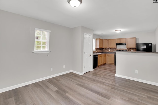 kitchen featuring refrigerator, tasteful backsplash, light wood-style floors, and light brown cabinets