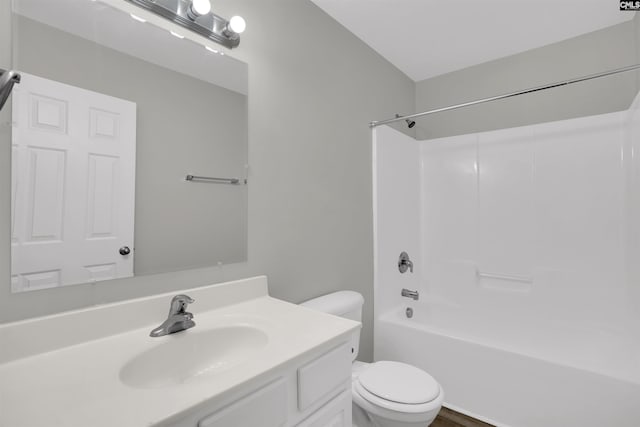 bathroom featuring toilet, shower / bathtub combination, and vanity