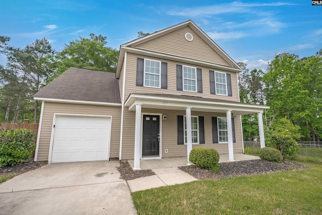 traditional-style home featuring a porch, driveway, a garage, and fence