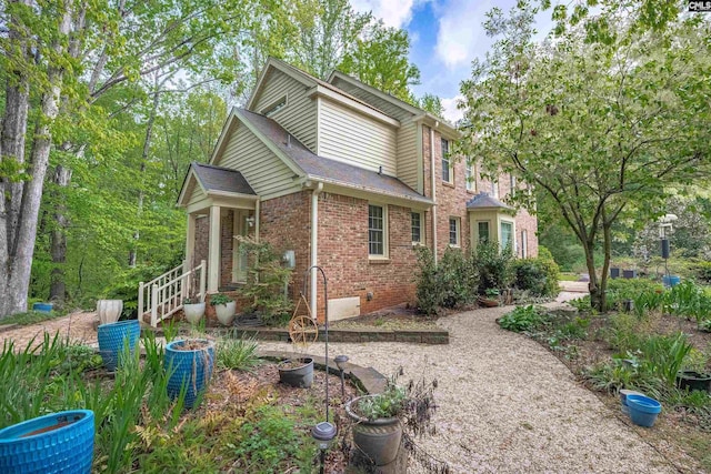 view of side of home featuring brick siding