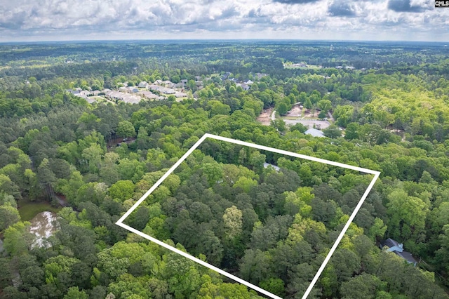birds eye view of property featuring a view of trees