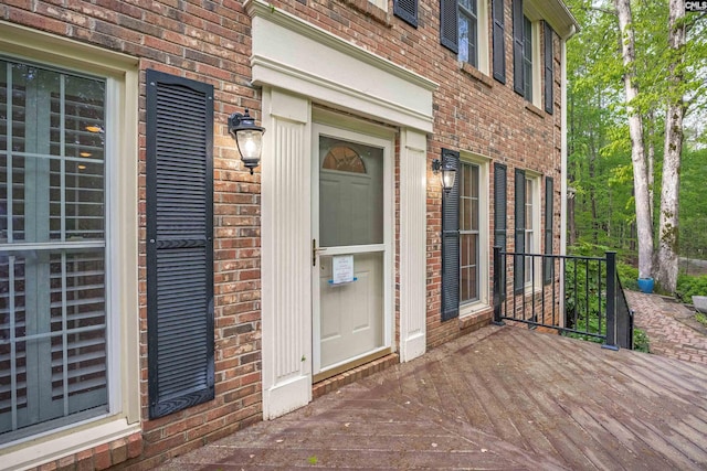 doorway to property with brick siding