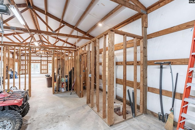 miscellaneous room with vaulted ceiling and unfinished concrete floors