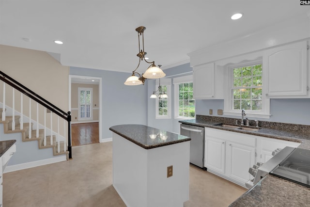 kitchen featuring a center island, white cabinetry, stainless steel dishwasher, and a sink