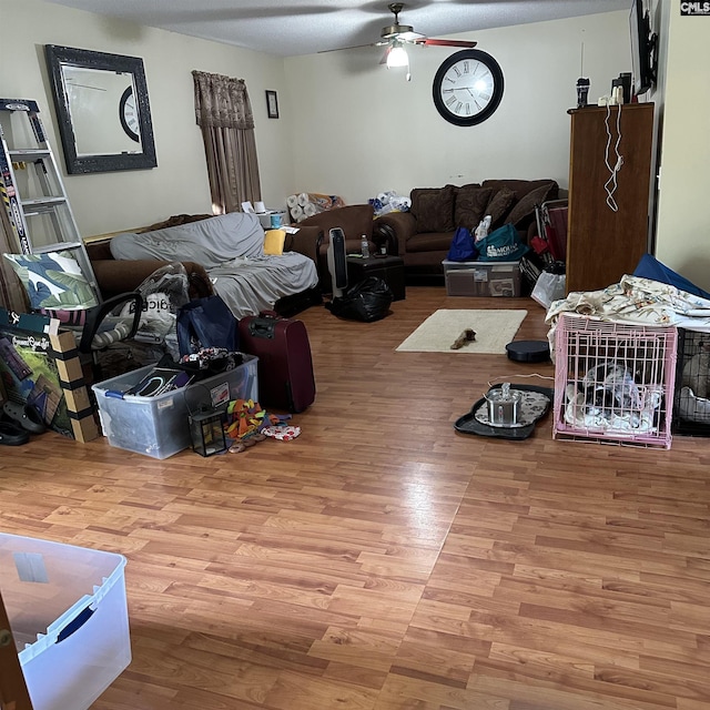 living room with ceiling fan and wood finished floors