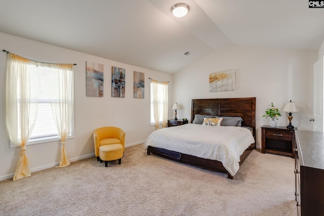bedroom featuring baseboards, vaulted ceiling, and light colored carpet