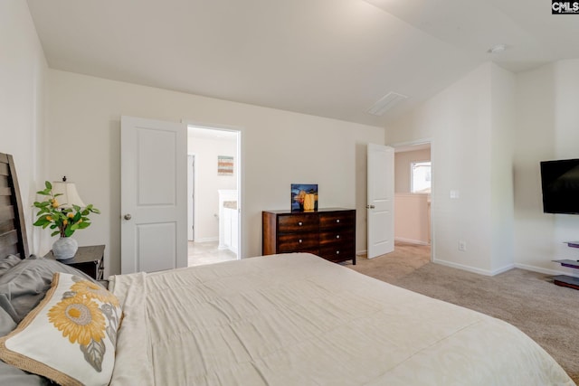carpeted bedroom featuring baseboards and lofted ceiling