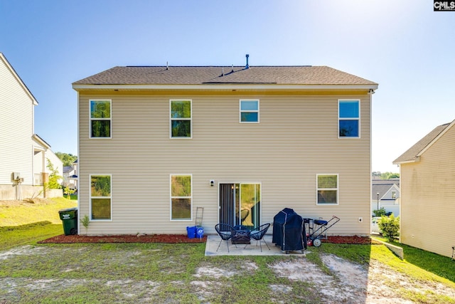back of property featuring a patio area and a yard