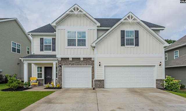 craftsman-style home featuring concrete driveway, stone siding, and board and batten siding