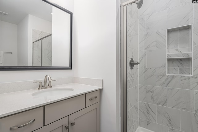 full bathroom with a stall shower and vanity