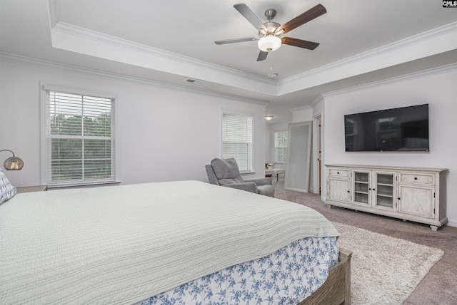 carpeted bedroom with a raised ceiling, crown molding, visible vents, and a ceiling fan