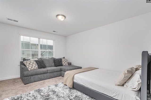 carpeted bedroom with visible vents and baseboards
