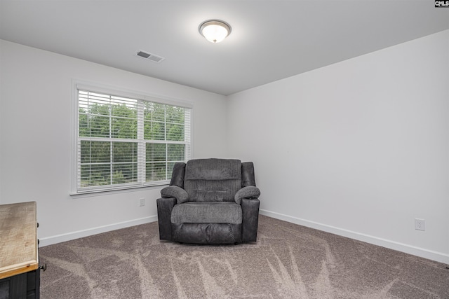 living area with carpet flooring, visible vents, and baseboards