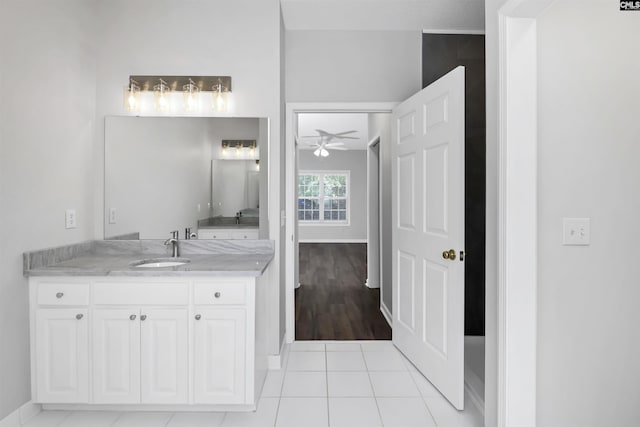 bathroom with baseboards, tile patterned floors, ceiling fan, and vanity