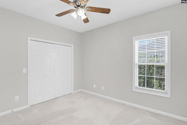 unfurnished bedroom featuring baseboards and light carpet