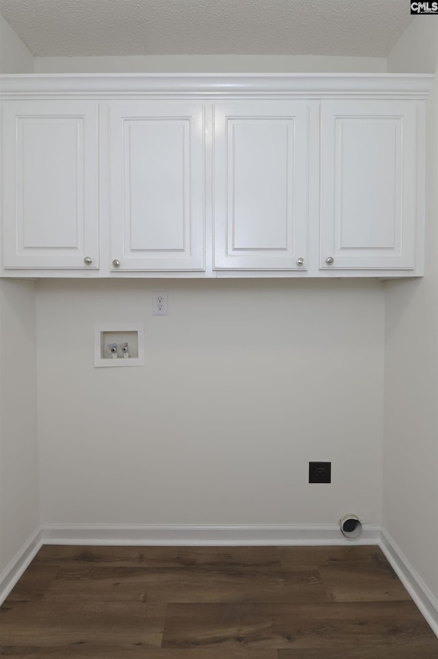 laundry area featuring hookup for a washing machine, cabinet space, dark wood-style floors, and baseboards