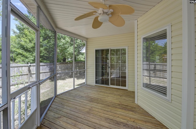 unfurnished sunroom featuring a ceiling fan