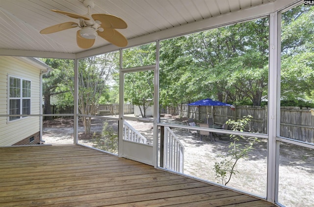 unfurnished sunroom with ceiling fan