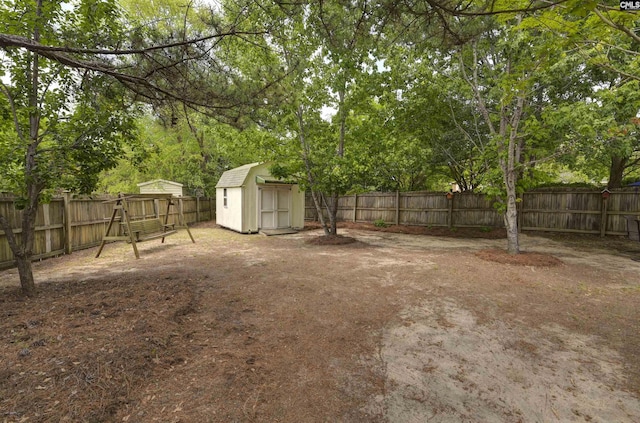 view of yard featuring an outdoor structure, a shed, and a fenced backyard