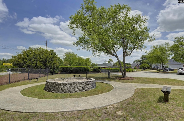 view of community featuring fence and a yard