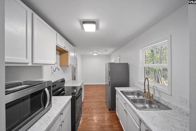 1203 Basil Rd, Swansea, SC 29160 - kitchen with white cabinetry, stainless steel appliances, wood finished floors, and a sink