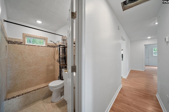 1203 Basil Rd, Swansea, SC 29160 - hallway with baseboards, wood finished floors, a wealth of natural light, and a textured ceiling