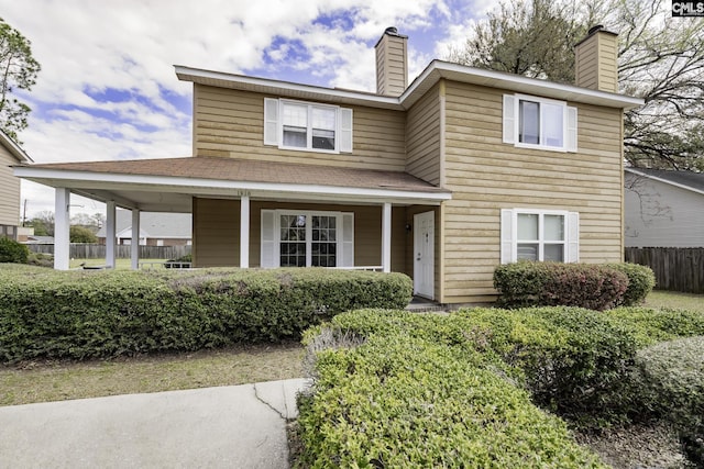 1910 Greenoaks Unit B, Columbia, SC 29206 - view of front facade with fence, roof with shingles, covered porch, and a chimney