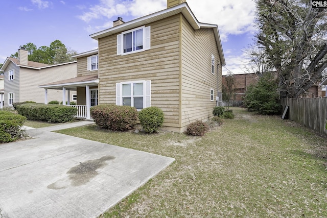 1910 Greenoaks Unit B, Columbia, SC 29206 - view of front of house featuring a chimney, fence, a front lawn, and a porch