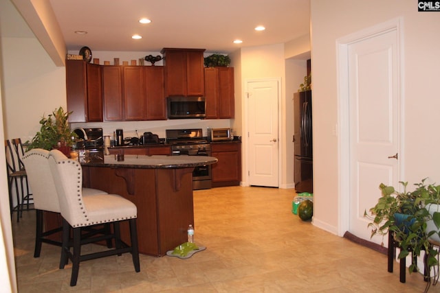 640 Mangrove Trl, Columbia, SC 29229 - kitchen with recessed lighting, a breakfast bar area, stainless steel appliances, and a peninsula