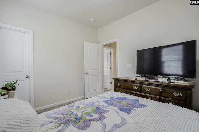 bedroom with carpet flooring and baseboards