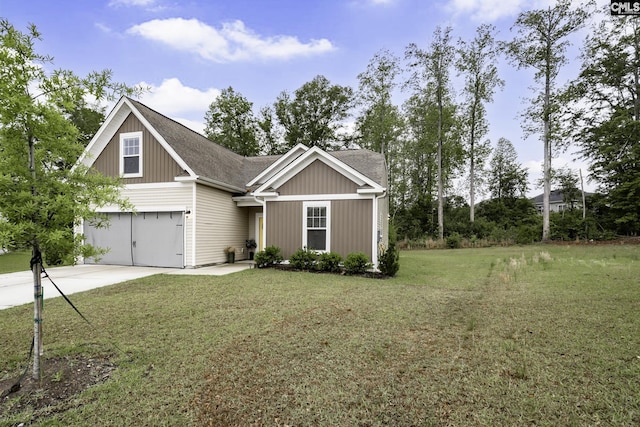 view of front of house with driveway, roof with shingles, a front yard, and a garage