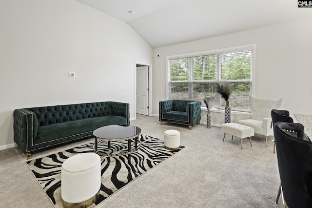 living area with baseboards, carpet flooring, and vaulted ceiling