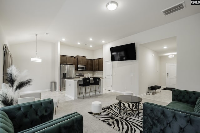 living area featuring recessed lighting, visible vents, and baseboards