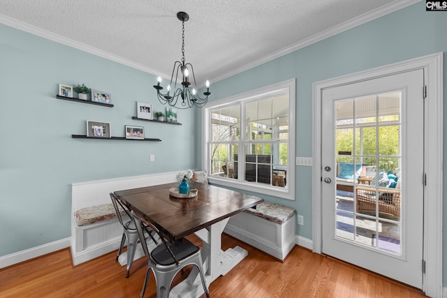 257 Popes Ln, Lexington, SC 29072 - dining room with breakfast area, a textured ceiling, ornamental molding, a chandelier, and light wood-style floors