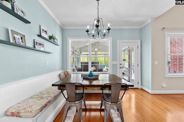 257 Popes Ln, Lexington, SC 29072 - dining space with light wood-type flooring, a chandelier, a textured ceiling, plenty of natural light, and crown molding