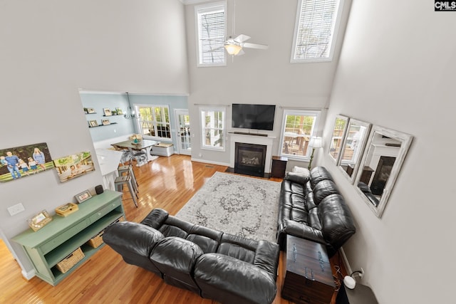257 Popes Ln, Lexington, SC 29072 - living room with wood finished floors, a high ceiling, ceiling fan, a fireplace with flush hearth, and plenty of natural light