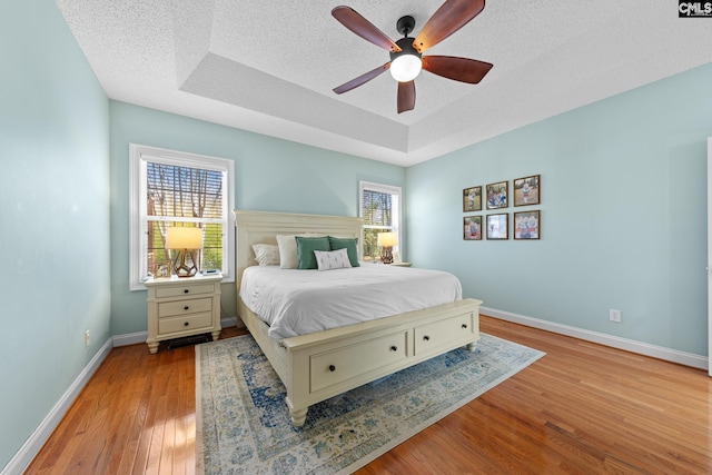 257 Popes Ln, Lexington, SC 29072 - bedroom featuring a raised ceiling, wood finished floors, baseboards, ceiling fan, and a textured ceiling