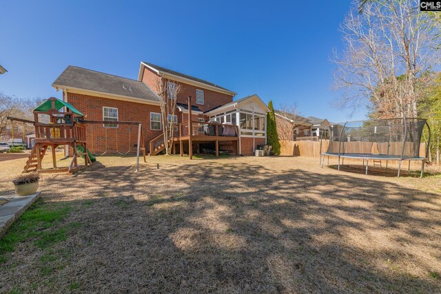 257 Popes Ln, Lexington, SC 29072 - back of house with a trampoline, a playground, brick siding, a deck, and stairs