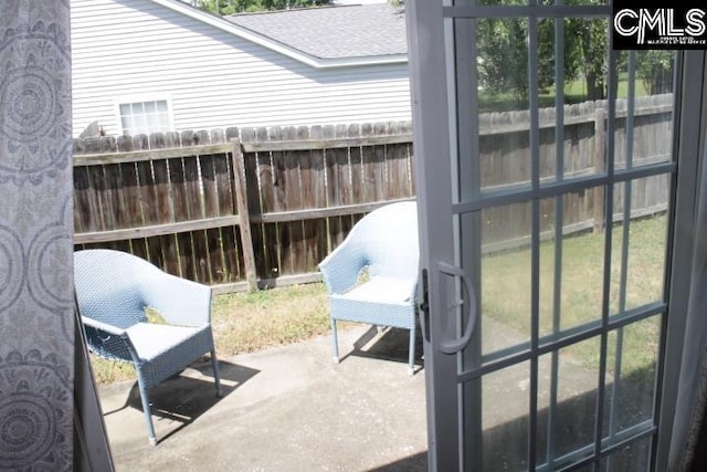 view of patio featuring fence