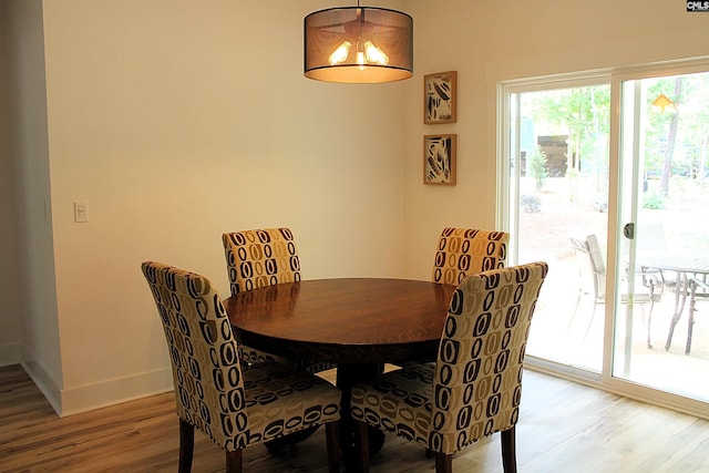 dining room featuring light wood-type flooring and baseboards