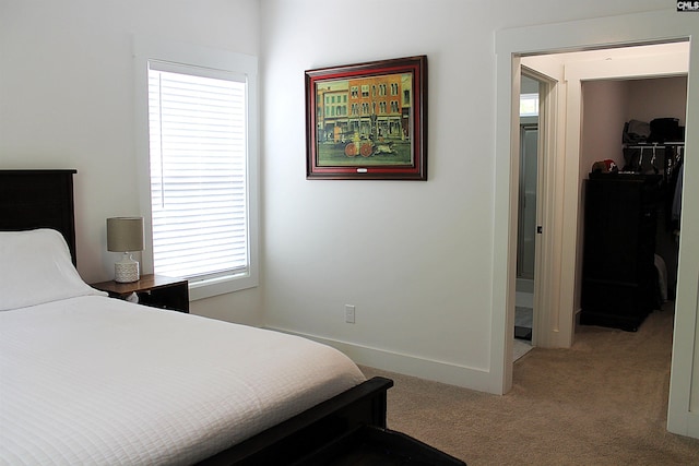 bedroom featuring light carpet and baseboards