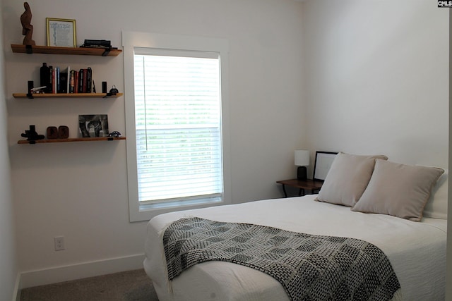 carpeted bedroom with baseboards