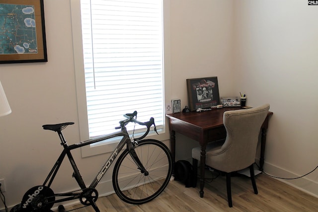 office space featuring baseboards and light wood-type flooring