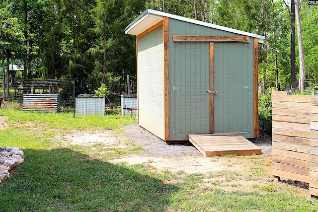 view of shed featuring fence