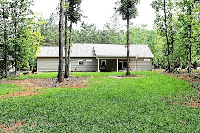 rear view of house with a lawn