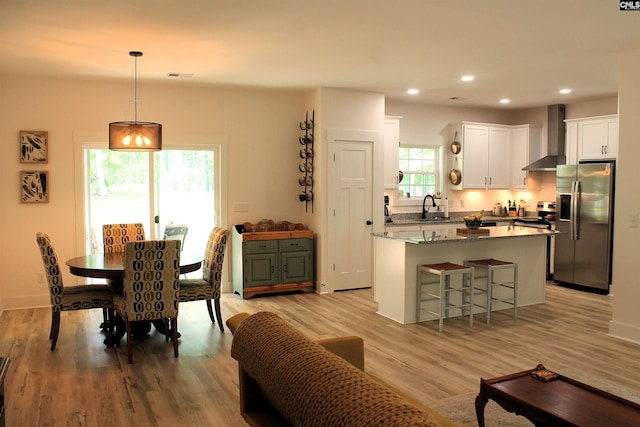 dining space with visible vents, light wood finished floors, and recessed lighting