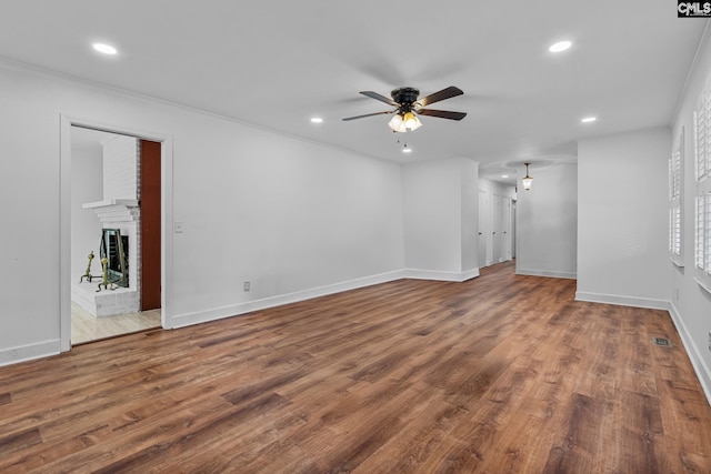 unfurnished living room with recessed lighting, ceiling fan, wood finished floors, and baseboards