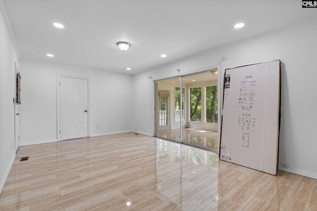 empty room with light wood-style floors, recessed lighting, and baseboards