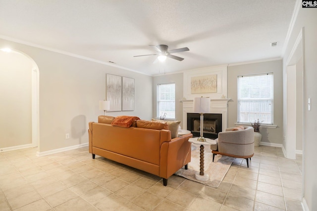 208 Bailey Island Cir, Lexington, SC 29072 - living area with a fireplace, light tile patterned floors, ceiling fan, crown molding, and arched walkways